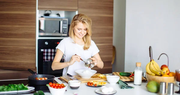 Frau mixt in Küche leckere Zutaten für Superfood-Salat mit Holzlöffeln — Stockfoto