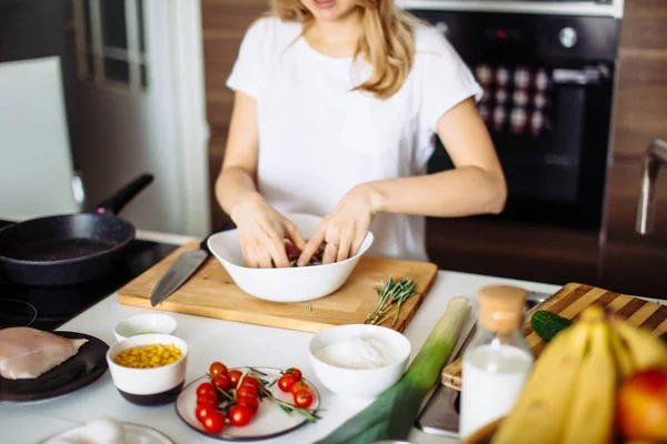 Home cozy kitchen chef pours salt on pork or beef meat with salt shaker Barbecue concept or healthy meat lifestyle shot — Stock Photo, Image