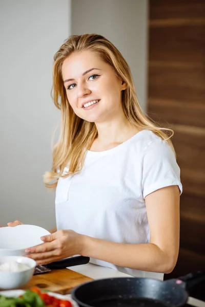 Belle femme blonde posant à table dans sa cuisine — Photo