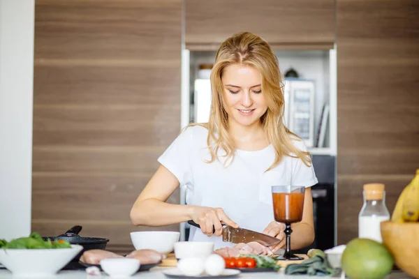 Frau schneidet mit großem Küchenmesser Hackfleisch auf einem Küchentisch — Stockfoto