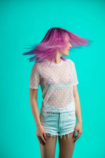 Подходящая женщина с фиолетовыми волосами, одетая в прозрачную блузку и шорты — стоковое фото