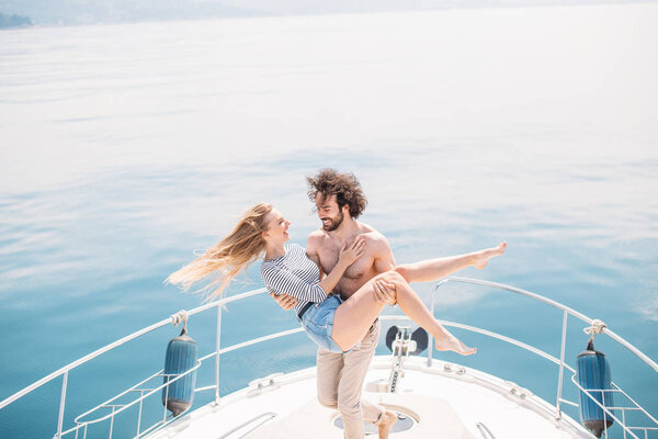 Hot dating lovers on the luxury boat in open sea in summer.