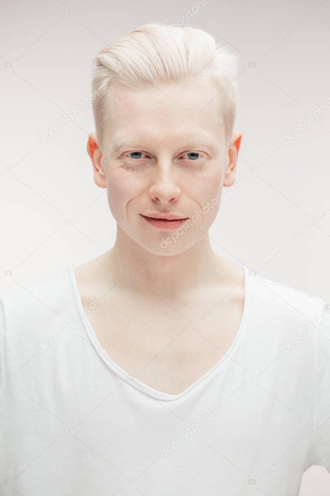 Fashion model male isolated on white. Handsome albino guy