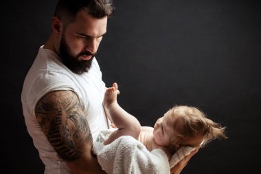 Ellerinde tutan babası şirin bebek. Aile, sevgi ve mutluluk kavramı