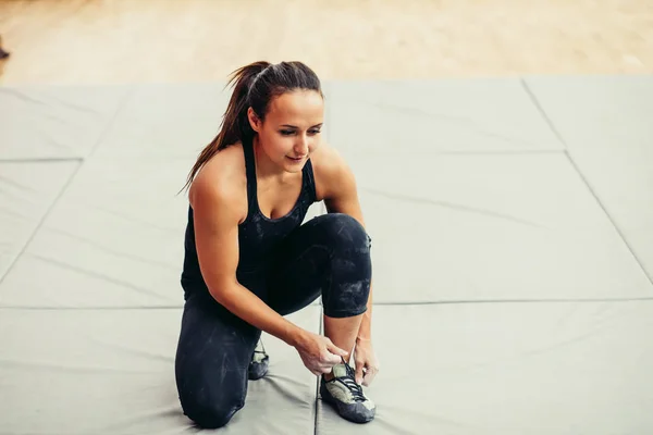 Femme est mis sur les chaussures de sport rose — Photo