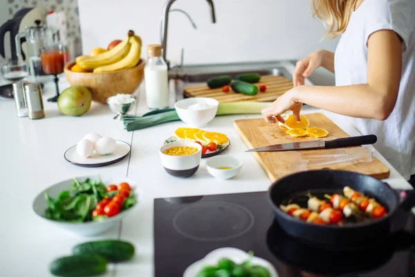 Young female chef cooking in kitchen — Stock Photo, Image