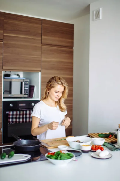 Pleasant young woman preparing dinner in a kitchen concept cooking, culinary — Stock Photo, Image