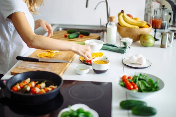 Young female chef cooking in kitchen — Stock Photo, Image