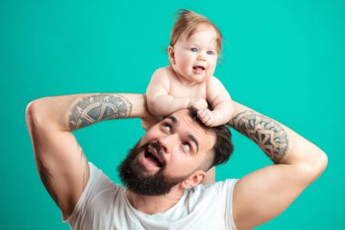 Mutlu baba bebek kızı üzerinde mavi arka plan izole boynunda taşıyan