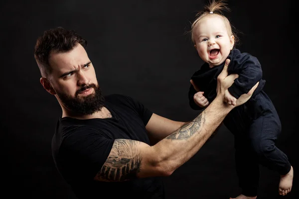 portrait of father holding on air his adorable child