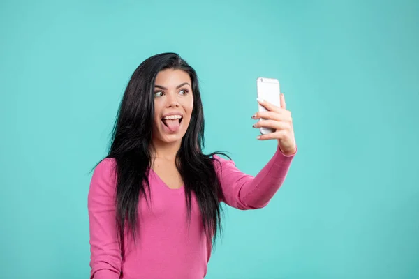 funny stylish girl doing selfie to send it to her friends