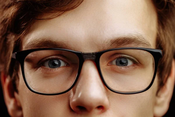 Close up half face of handsome fair-haired male with kind blue eyes — Stock Photo, Image