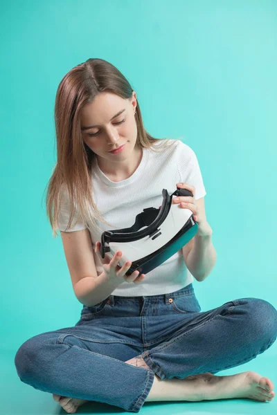 Close up full length portrait of sitting woman checking VR glasses — Stock Photo, Image