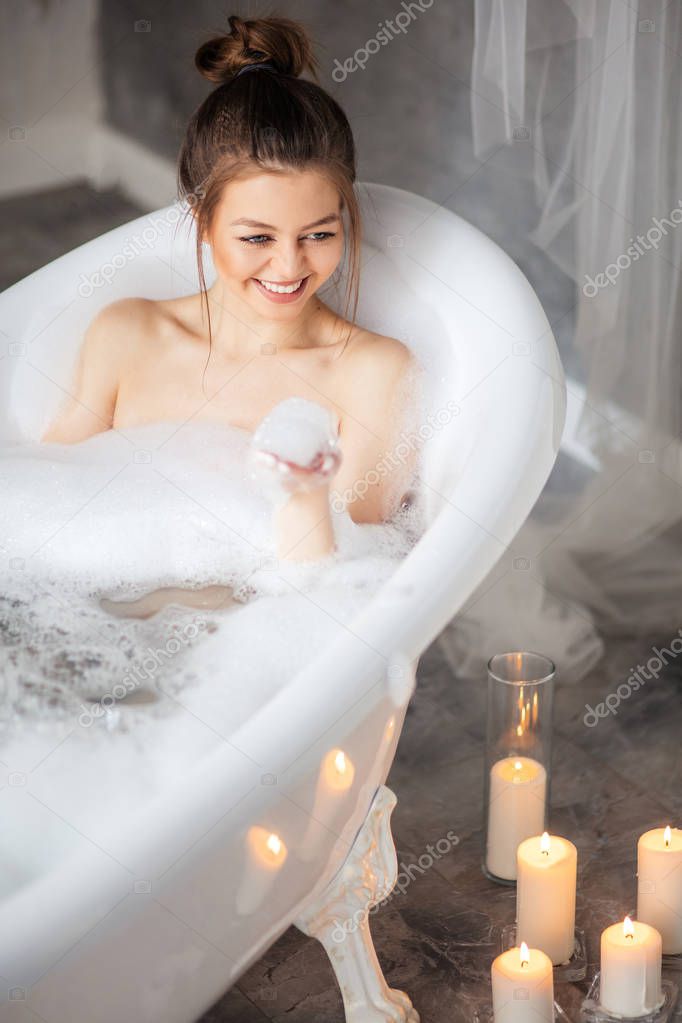 pleasant girl enjoying bubble bath
