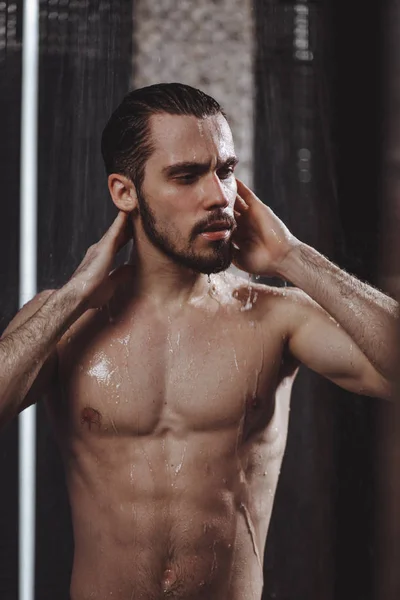 Bearded pleasant guy is enjoying the hot shower — Stockfoto