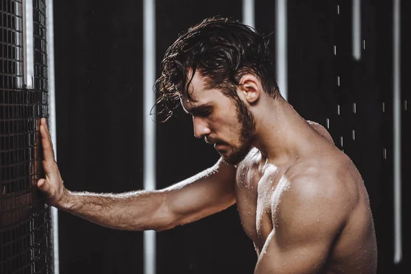 exhausted sportsman in the shower bath