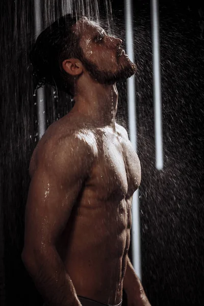 Young man enjoying taking a shower Stock Photo