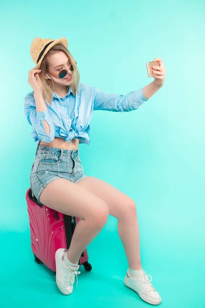 stock image young pleasant woman using her mobile phone as a mirror