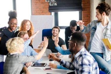 a group of friends is trying ti make high five together clipart