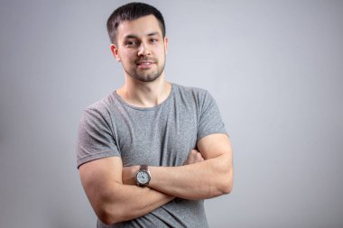 Portrait of a young strong man with crossed arms clipart