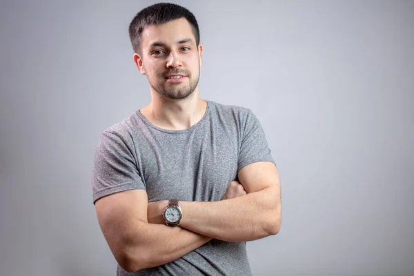 Portrait of a young strong man with crossed arms — Stock Photo, Image