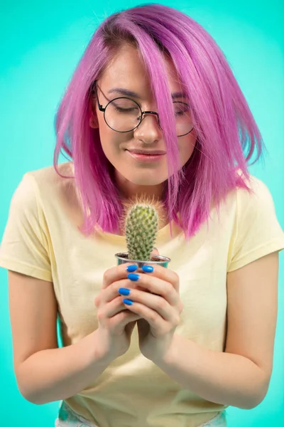 Emotional woman holding potted plan in hands — Stock Photo, Image