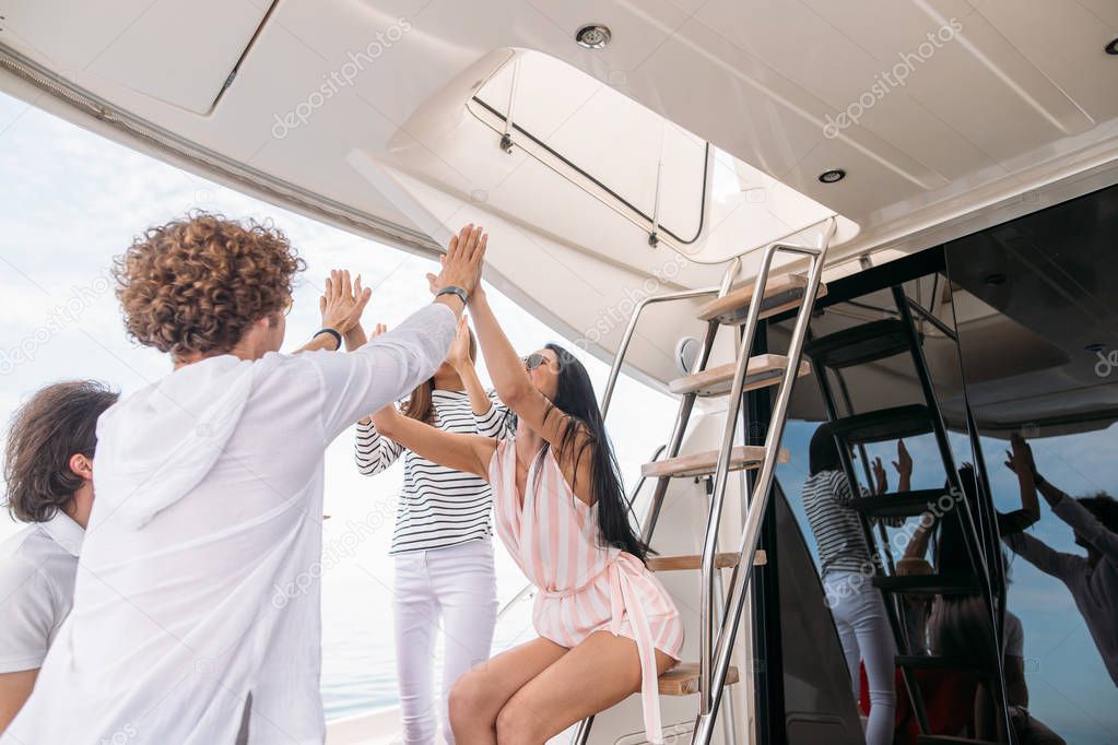 Group of friends making party on a yacht, having a fancy party on a luxury boat