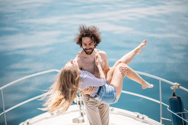 Hot dating lovers on the luxury boat in open sea in summer.