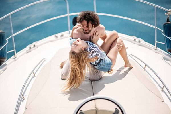 Hot dating lovers on the luxury boat in open sea in summer.