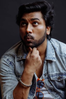 dalgın adam çenesine dokunuyor ve ararken