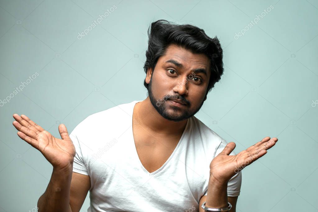 handsome Indian man showing indifference to the problem, situation