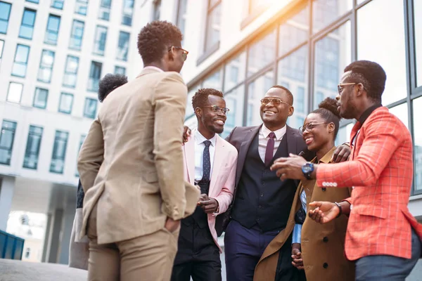 positive business people are hugging on the street