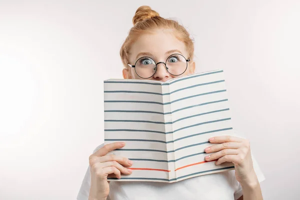 surprised girl holding a book.