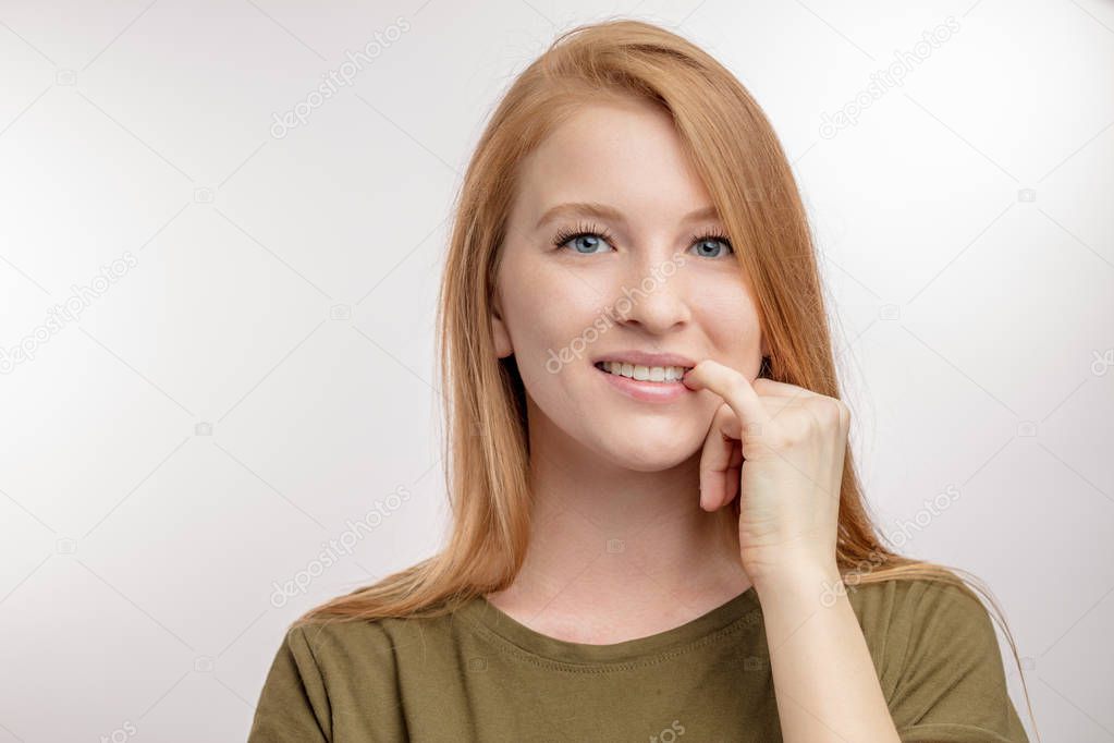 beautifyl young woman is biting her nails. bad habbit concept