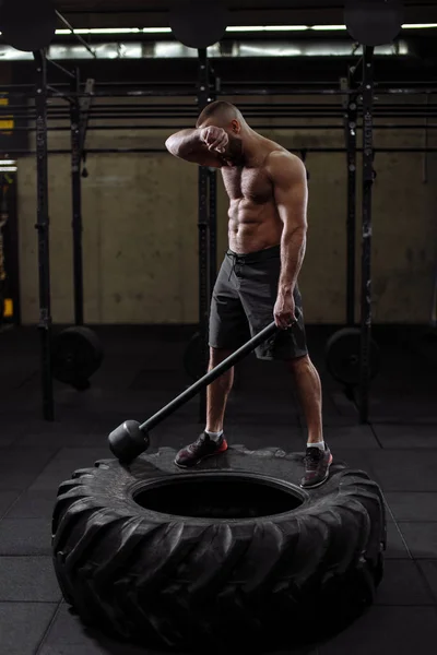 exhausted sportsman is mopping his brow after hard training