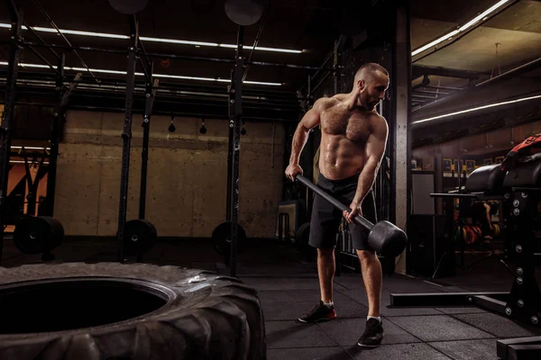 Hombre musculoso fuerte con martillo está mirando hacia atrás —  Fotos de Stock