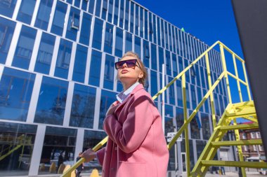 Genç kadın turist sarı basamakta dururlar