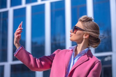 genç model pembe ceket fotoğraf çekmek çalışıyor