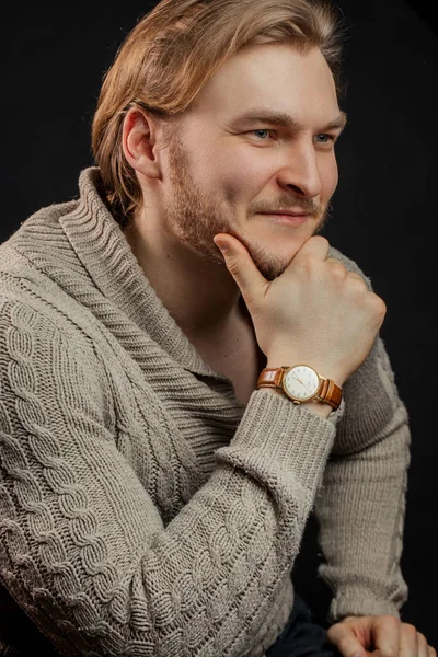 smiling good-looking powerful man leaning on his hand