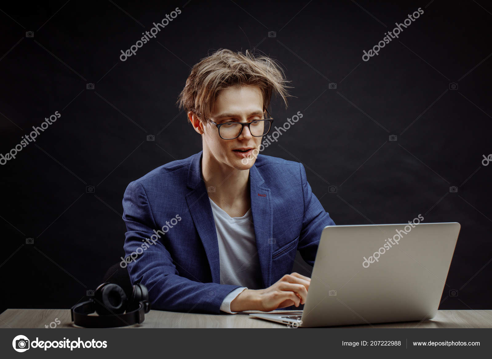 Funny Young Man With Long Brown Tousled Hair Using A Computer