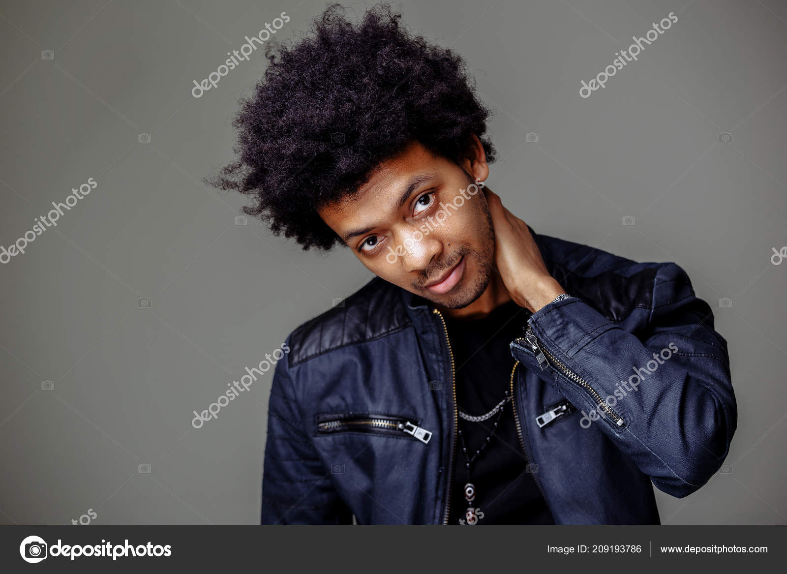 Guy with African hairstyle and dark skin looking cheerfully into camera  Stock Photo by ©ufabizphoto 209193786