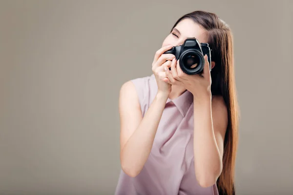 Woman photographer is taking images with dslr camera