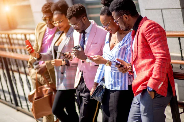 Módní lidí tráví čas na mobilních telefonech — Stock fotografie