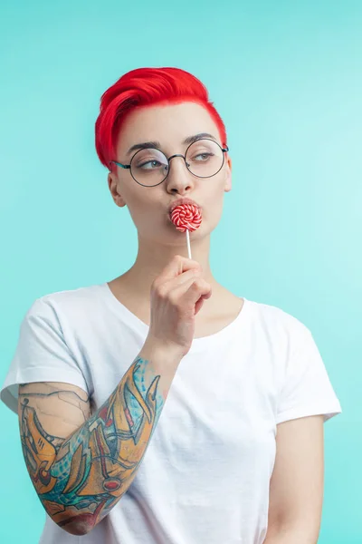 Pensive girl with lollipop on her mouth — Stock Photo, Image