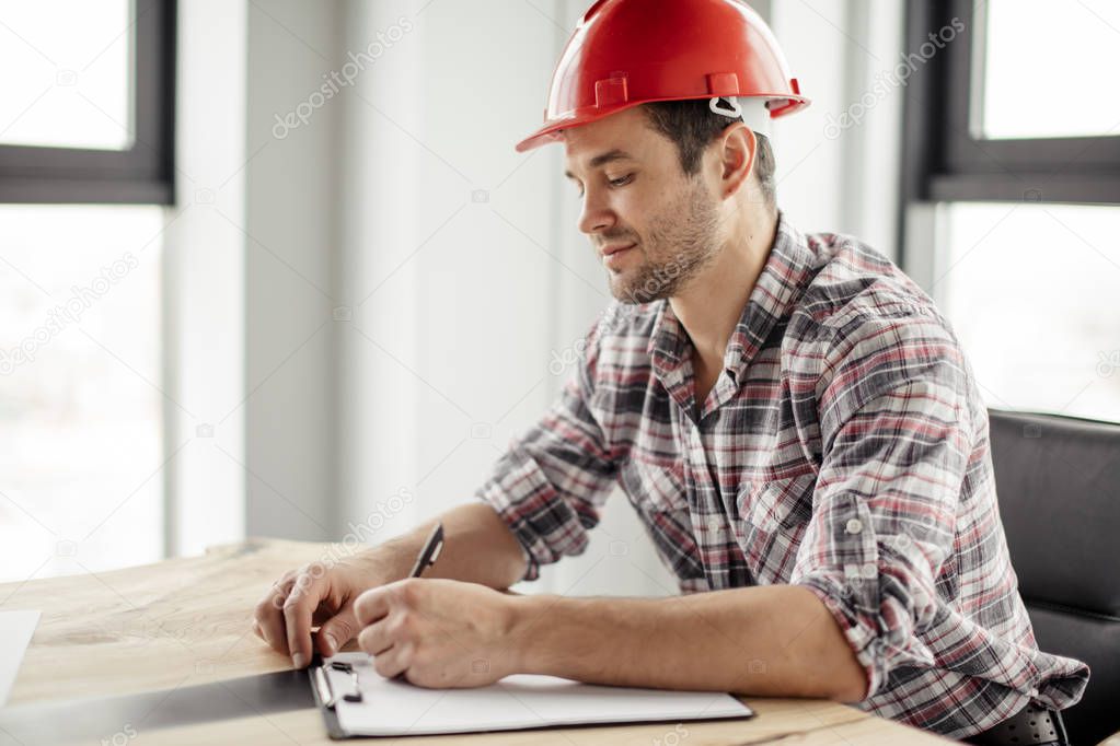 attractive awesome constructor is writing down the costs for reconstruction