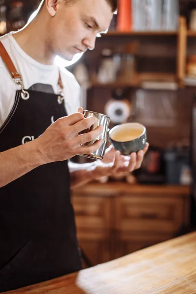 Handsome man is making latte — Stock Photo, Image