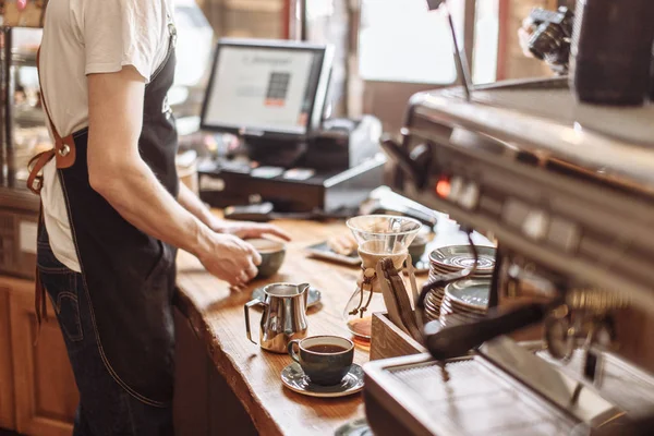 Salesman is making espresso for clients — Stock Photo, Image