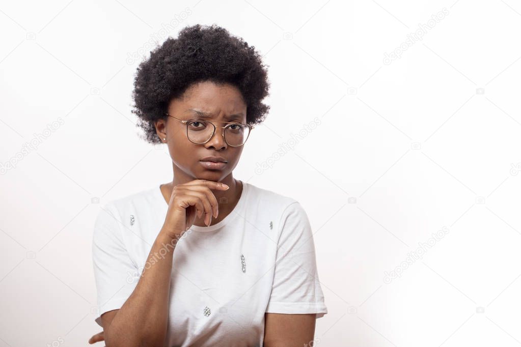 frowning young good looking african female in glasses