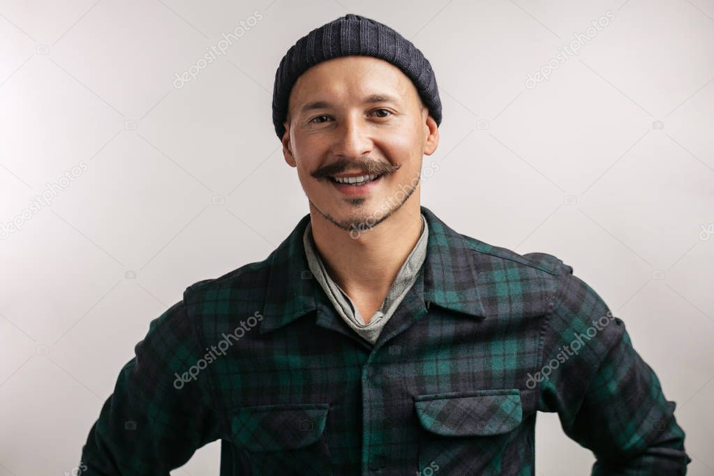 smart professional expert handyman wearing knitted hat isolated in studio