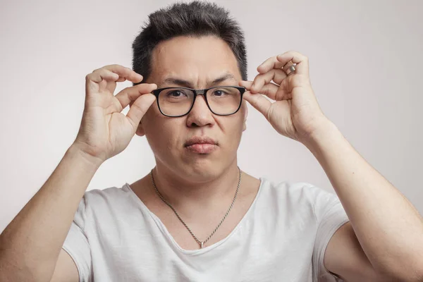 Asian man with suspicion and disbelief on his face, mixed with disapproval — Stock Photo, Image